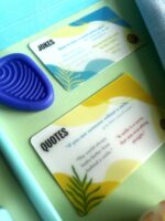 A blue plastic guitar pick and two cards.