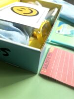 A box with some papers and a yellow object